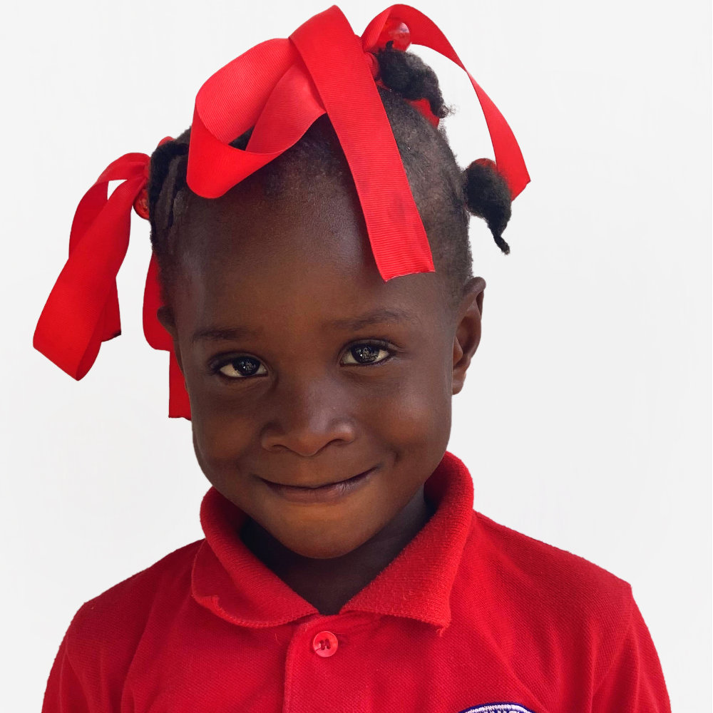 Little Haitian girl with ribbons in hair.