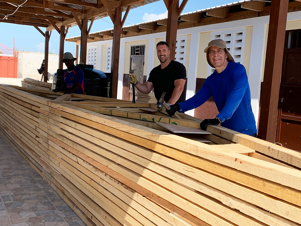 Volunteers measuring roof beams