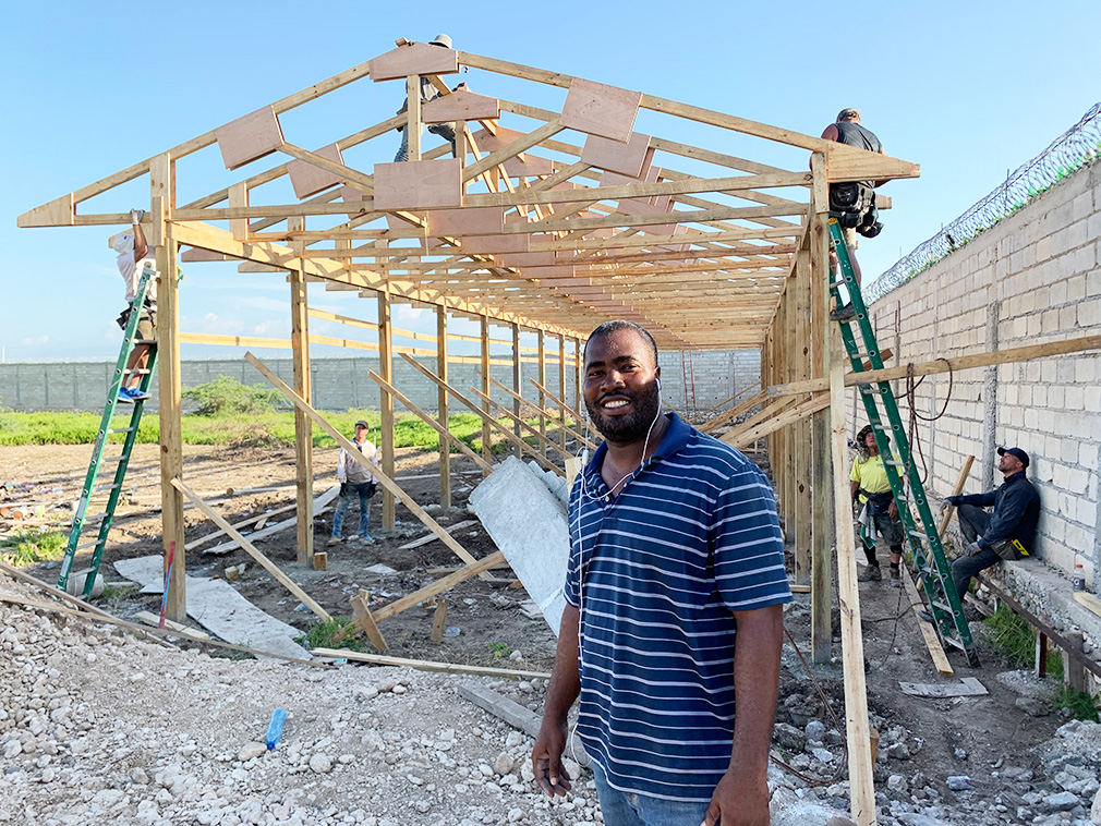 pastor poyis in front of trusses