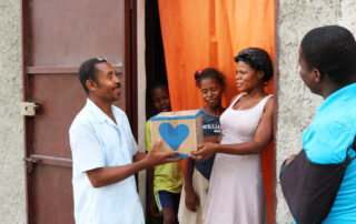 pastor distributing food in haiti