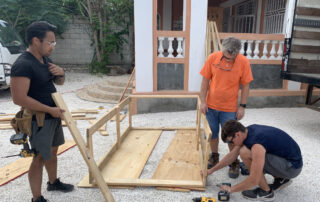 volunteers building frame for children's home in Haiti