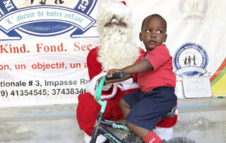 boy on bike with Santa