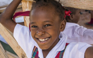 female child in school uniform posing and smiling