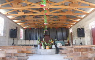 the inside of a flower decorated church in Haiti