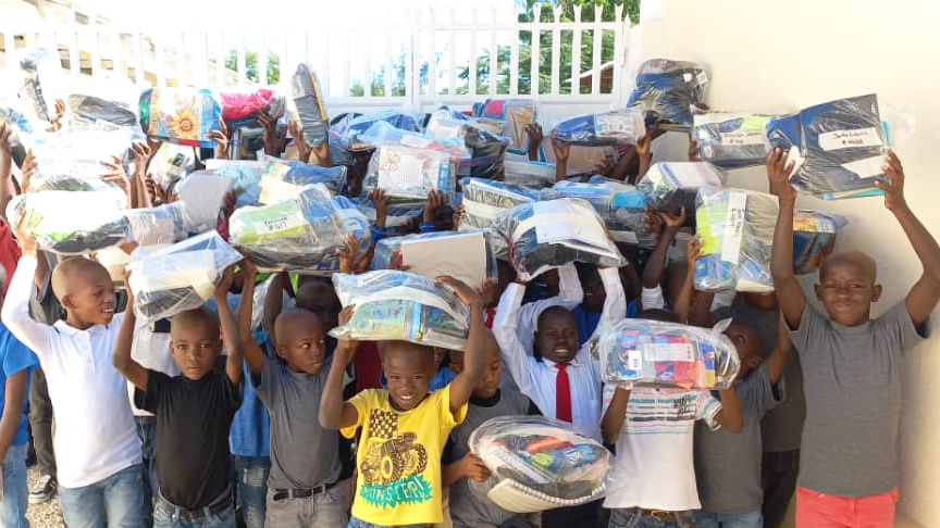 A group of Haitian children with packages.