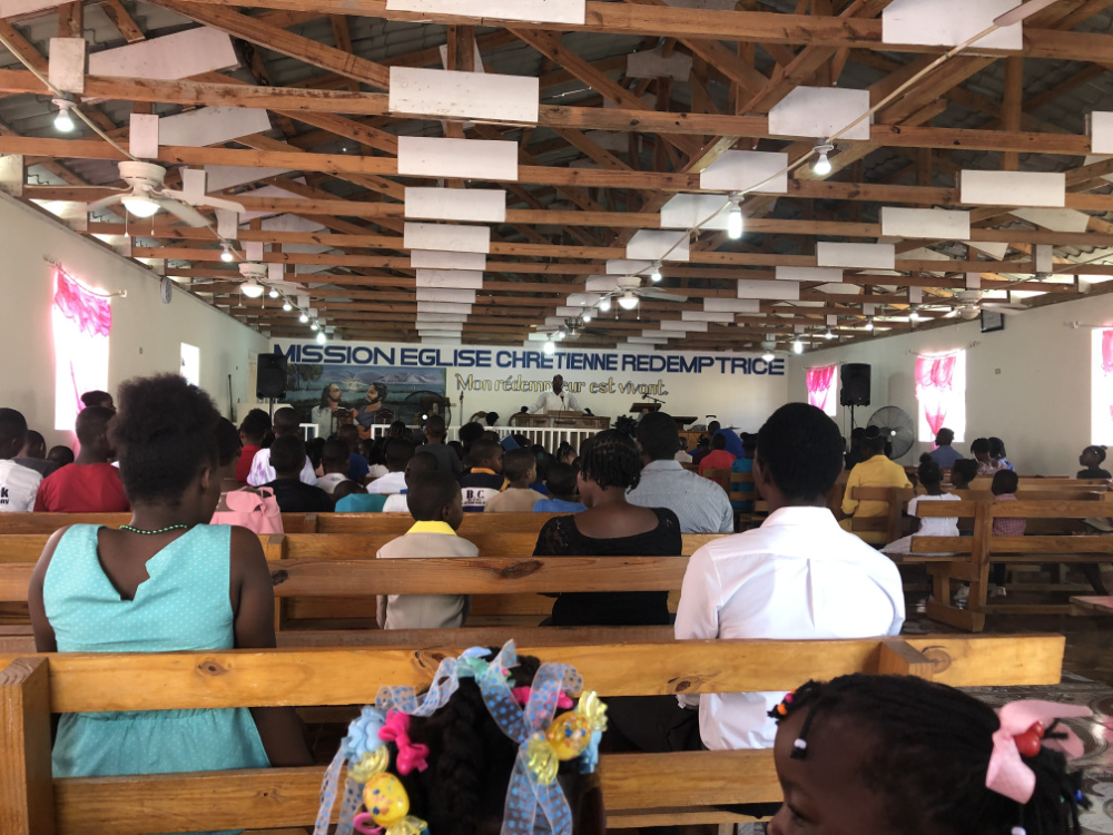 Church congregation sitting patiently waiting for prayer to begin