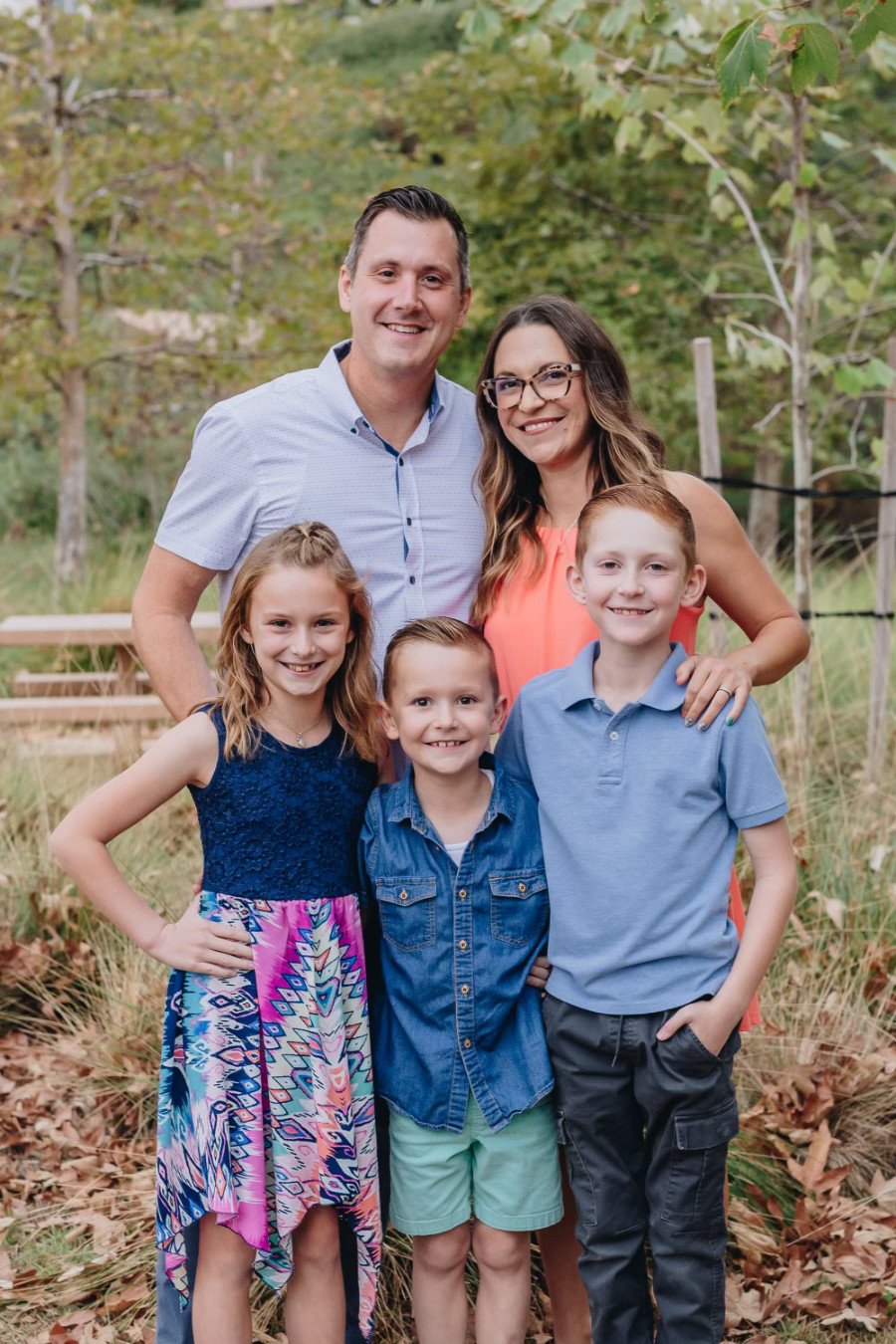 Dell family portrait in the woods.