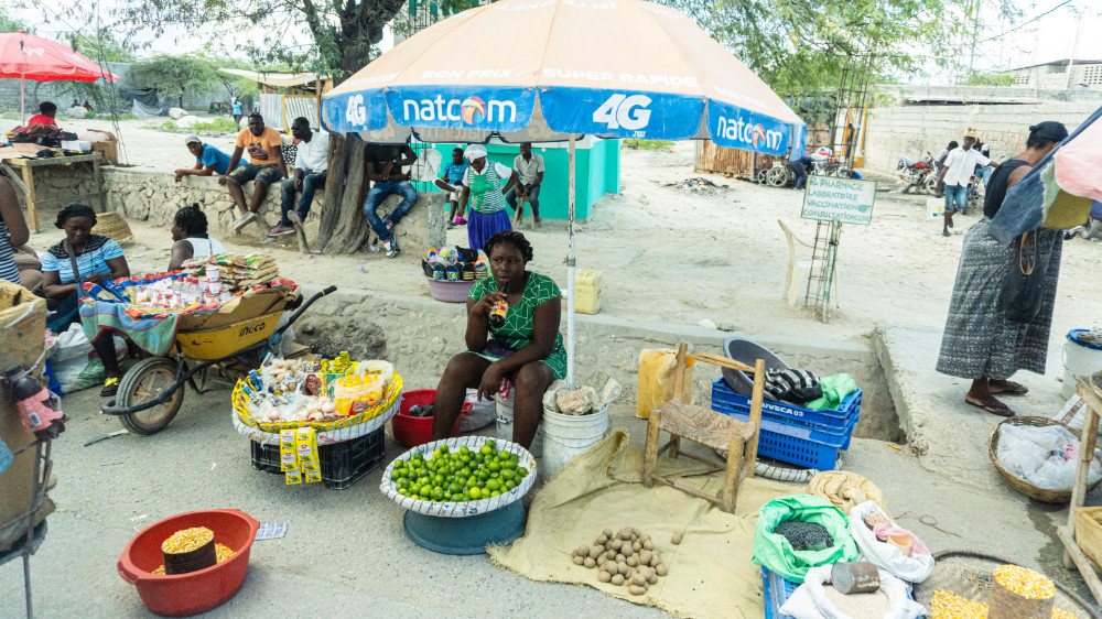 Market vendors in the streets of Haiti selling produce and other goods.