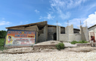 A crumbling Haitian building made of cinder block.