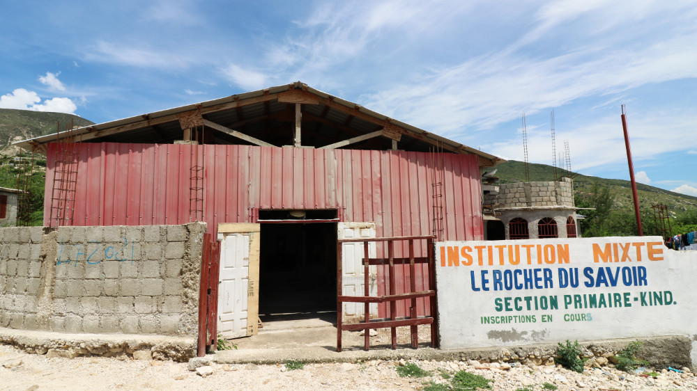 A Haitian building made of sheet metal painted red.