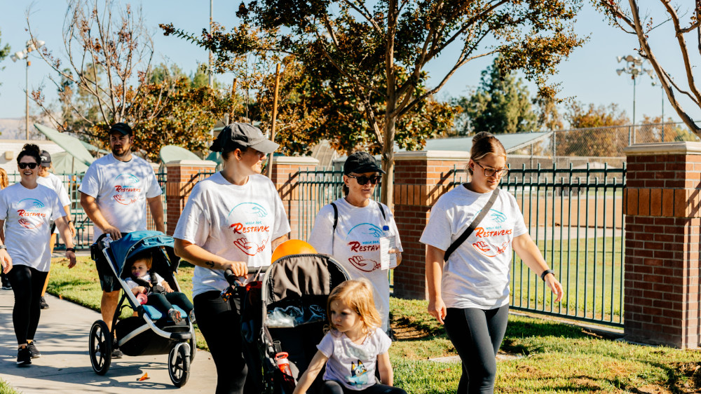 Families walking with strollers at simi walk in the park.
