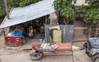 Ariel view of a rural home with a slanted tin roof in Haiti