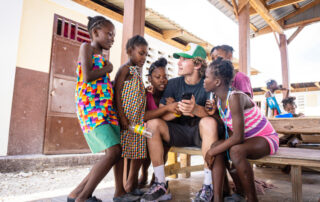 Haiti 2021 Volunteer showing iPhone to girls