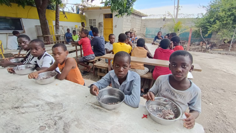 Children eating rice and beans.