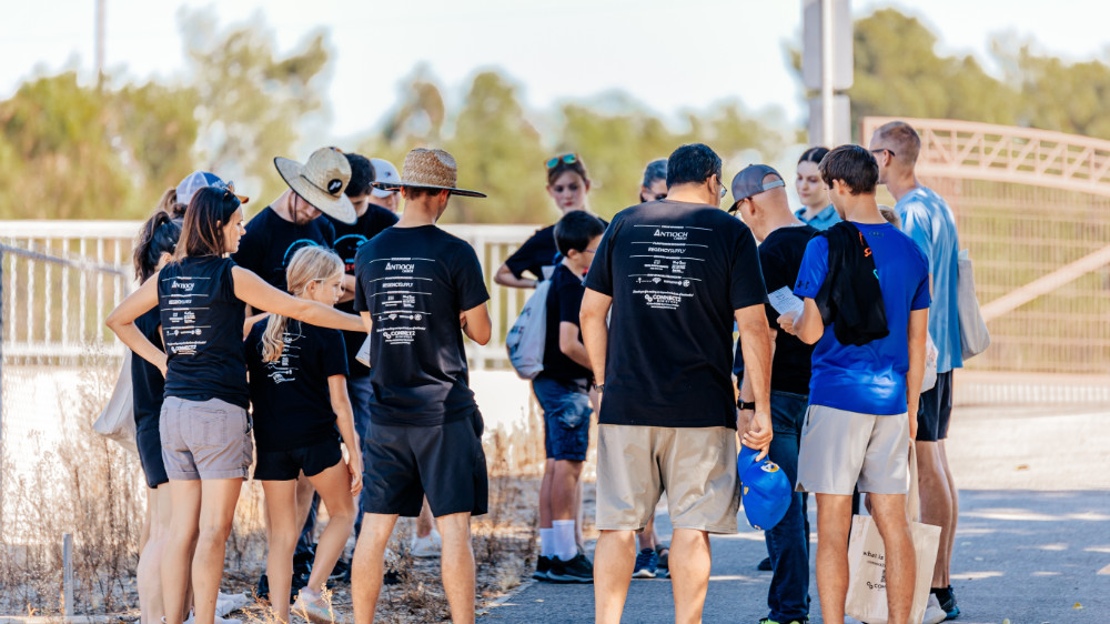 Volunteers in a circle praying