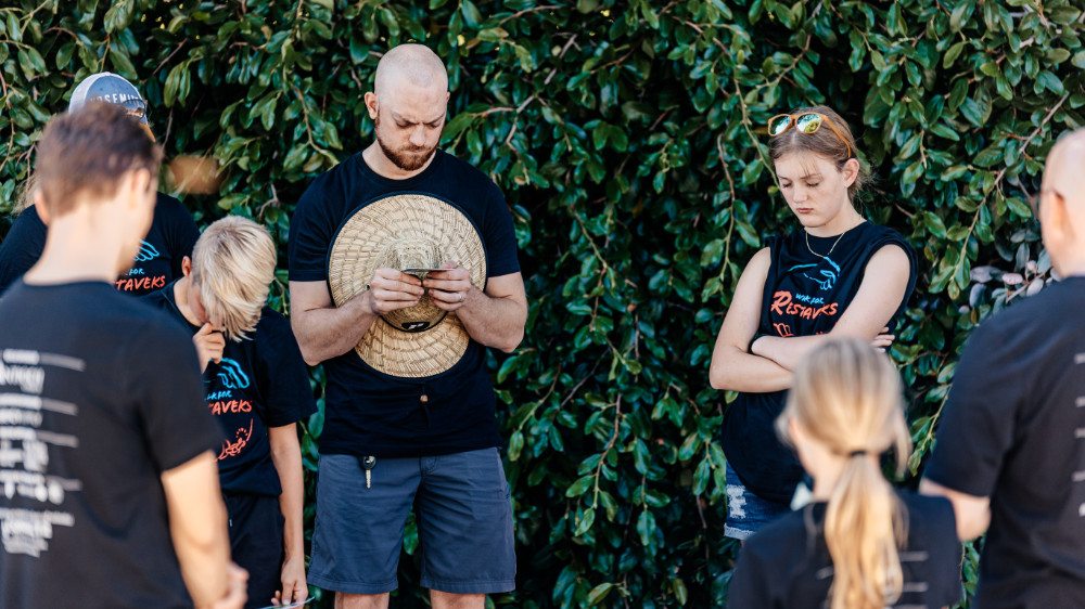 Volunteers in a circle praying