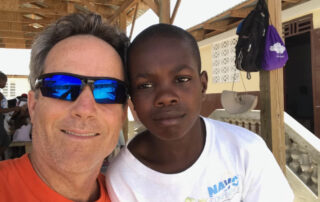 John McHale and Haitian boy taking a picture