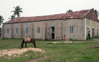 Horse and children in front of an old church building.