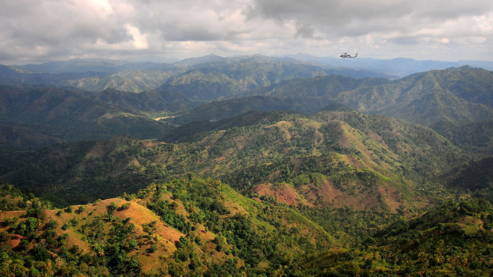 Helicopter flying over Haiti mountainous range